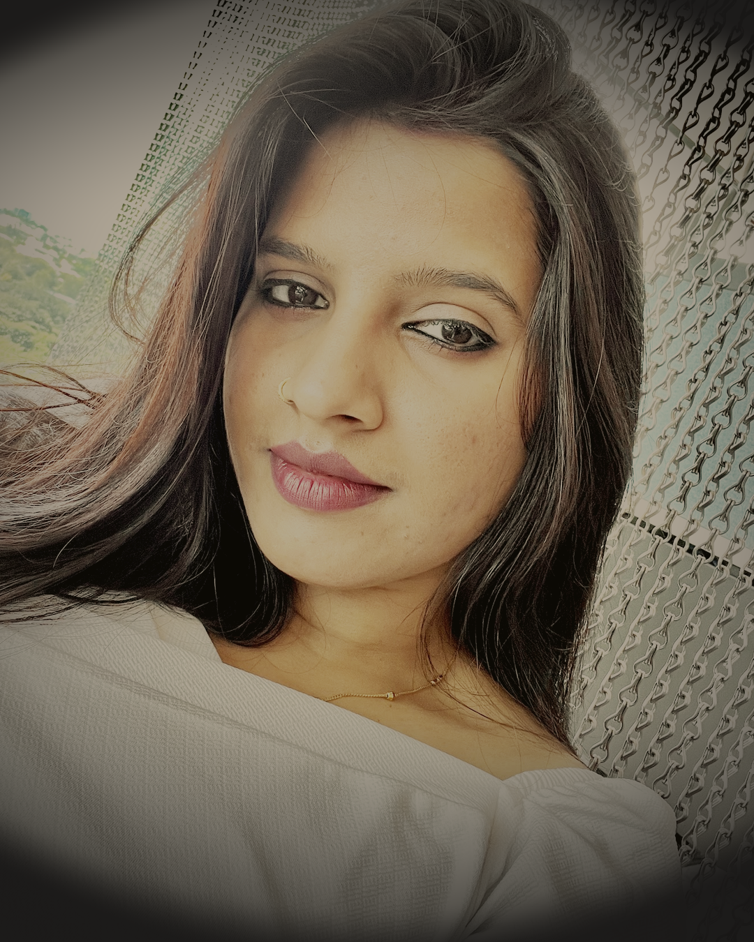 Portrait of Rashmi Kumari, softly lit against a dark charcoal backdrop